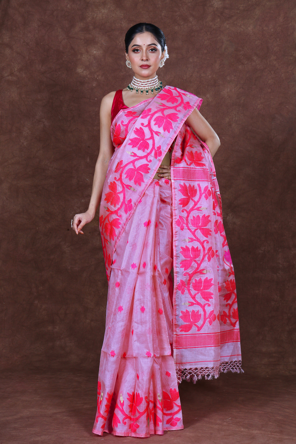 Tussar Jamdani saree made from textured tussar silk featuring intricate handwoven Jamdani motifs in contrasting threads, with delicate floral and geometric patterns spread across the body and an ornate woven border, showcasing a soft golden-beige base with artisanal detailing.